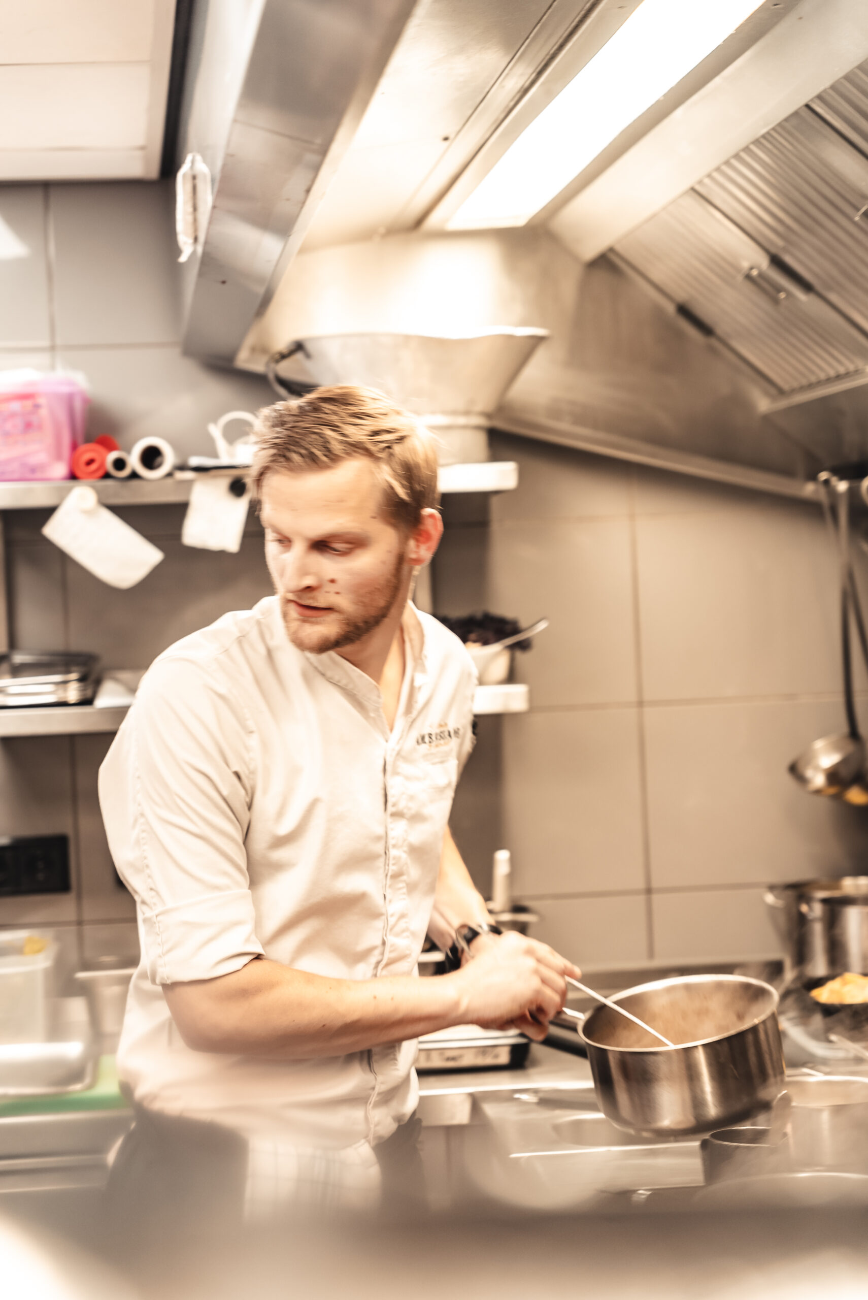 Chef preparing a dish in the kitchen at Brasserie Ambassade in Amsterdam
