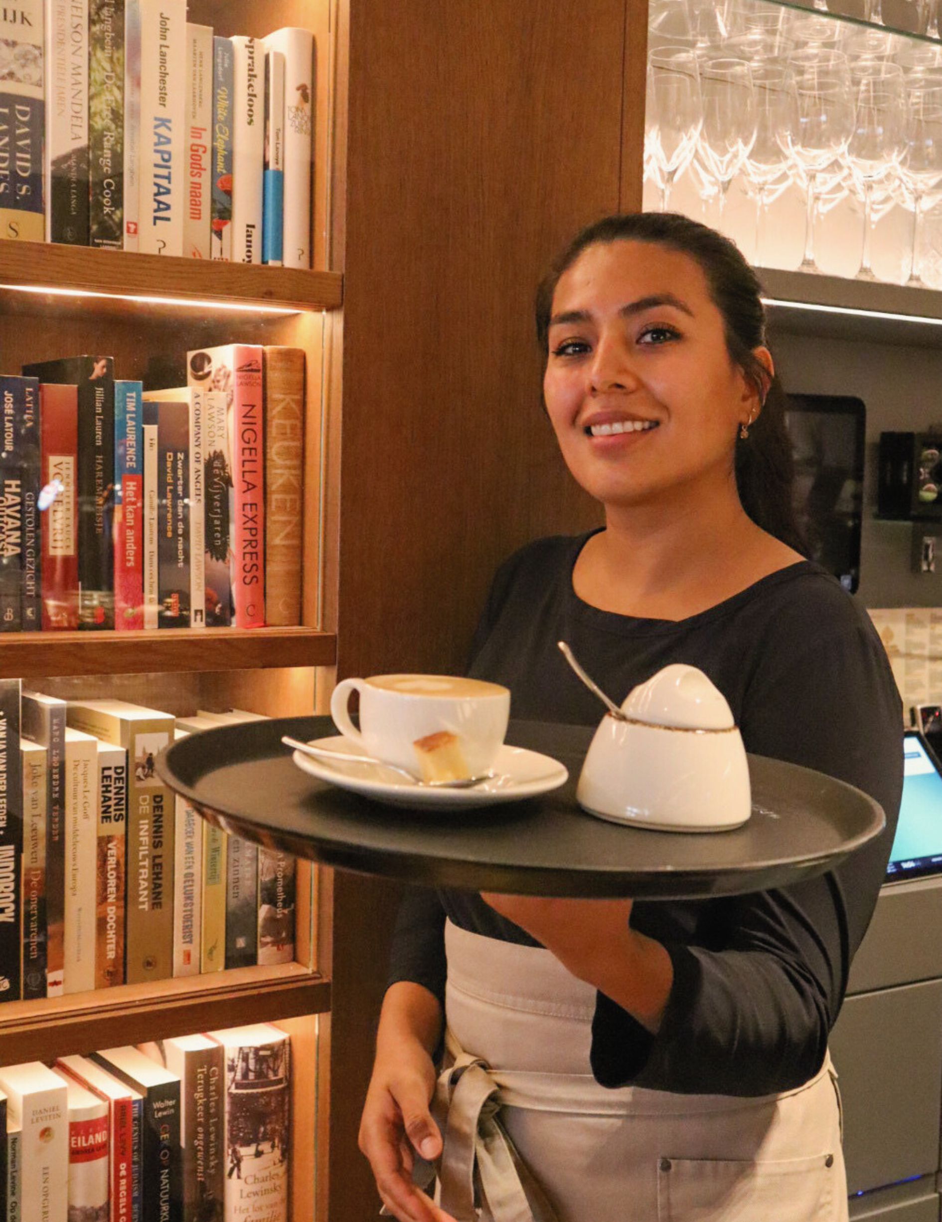 Staff serving coffee in the Library Bar at the Ambassade Hotel in Amsterdam